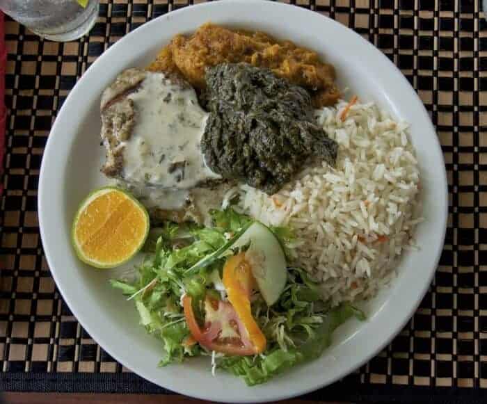 A traditional lunch with grilled fish and nutmeg sauce, stewed pumpkin and callaloo in Grenada