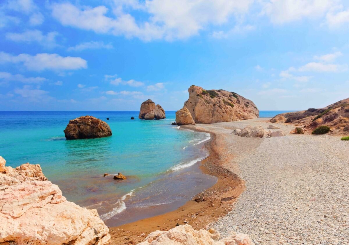 Aphrodite Rock surrounded by azure blue water.