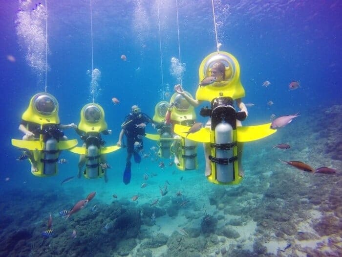 People viewing the underwater reef of Curacao on an Aquafari
