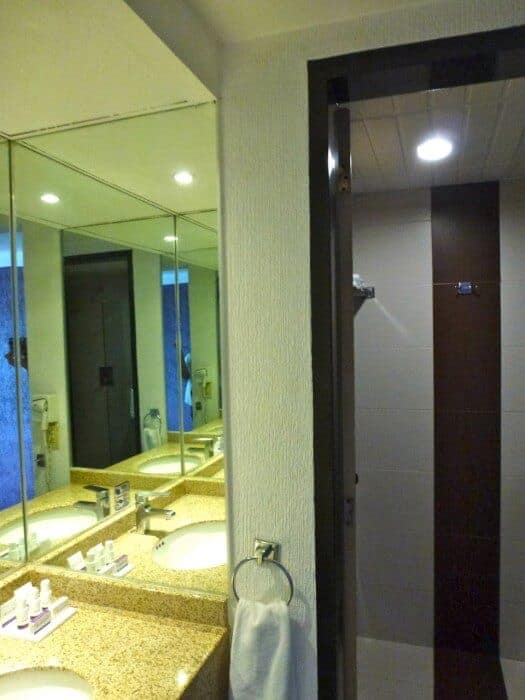 Bathroom with mirror and yellow countertop at Grand Prix hotel. 