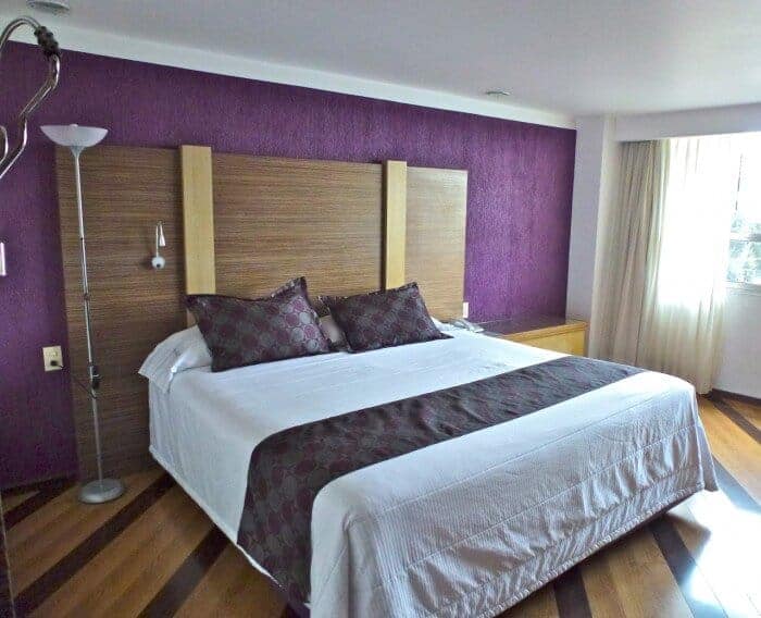 King-size room with purple bedspread at Grand Prix Hotel in Mexico City.