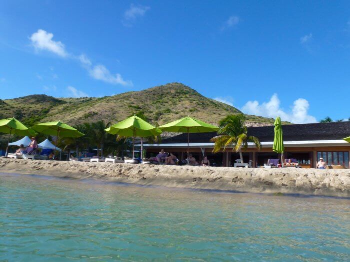 View of green beach umbrellas at Carambola Beach Club in St Kitts 