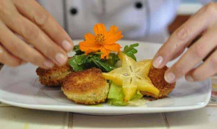 Crab cakes decorated with flowers at Arte Culinario cooking school in Puerto Vallarta, Mexico.