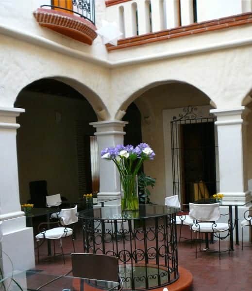 Chairs and pillars of interior courtyard at Casa Catrina hotel in Oaxaca City Mexico. 