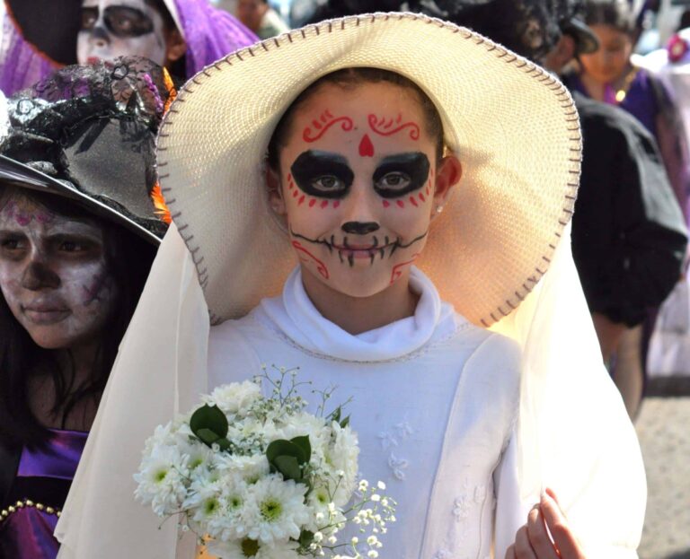 A young girl dressed as a catrina on Day of the Dead in Mexico.