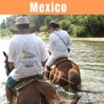 Two people horseback riding to Atotonilco Hot Springs near Puerto Escondido.