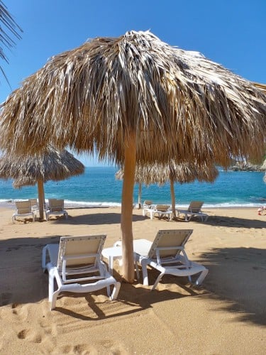 Loungers on the beach at Secrets Huatulco. 