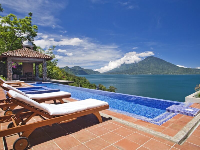 Two lounge chairs overlooking the infinity pool at Casa Polopo in Guatemala.