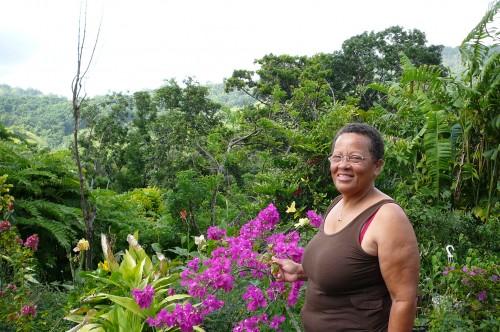 Woman in front of a Creole garden in Martinique.