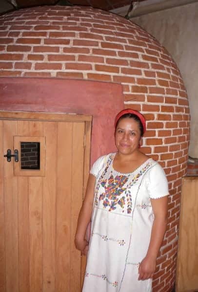 Female shaman standing in front of a temazcal in Oaxaca City, Mexico. 