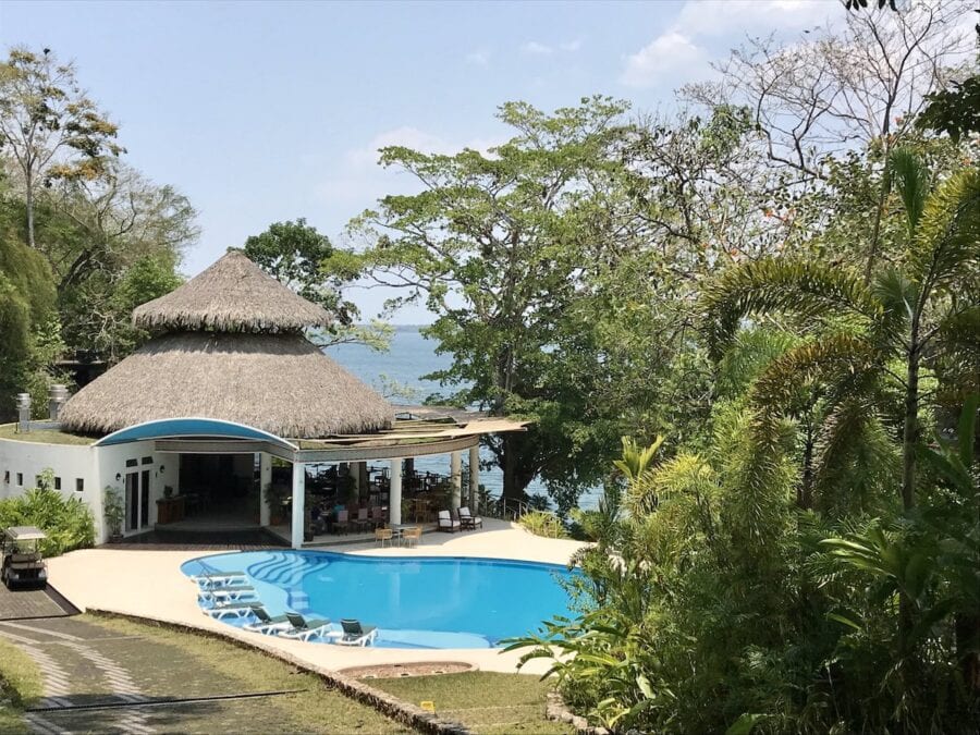 Swimming pool and restaurant at Bolontiku Resort in Guatemala. 