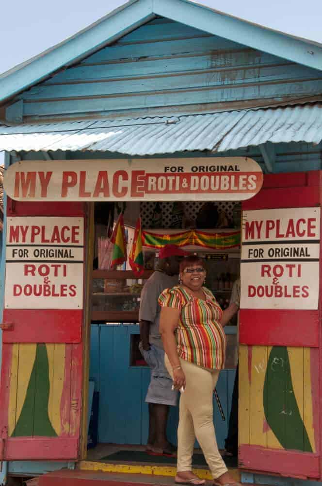 Woman standing in doorway of roti shop in Grenville Grenada. 