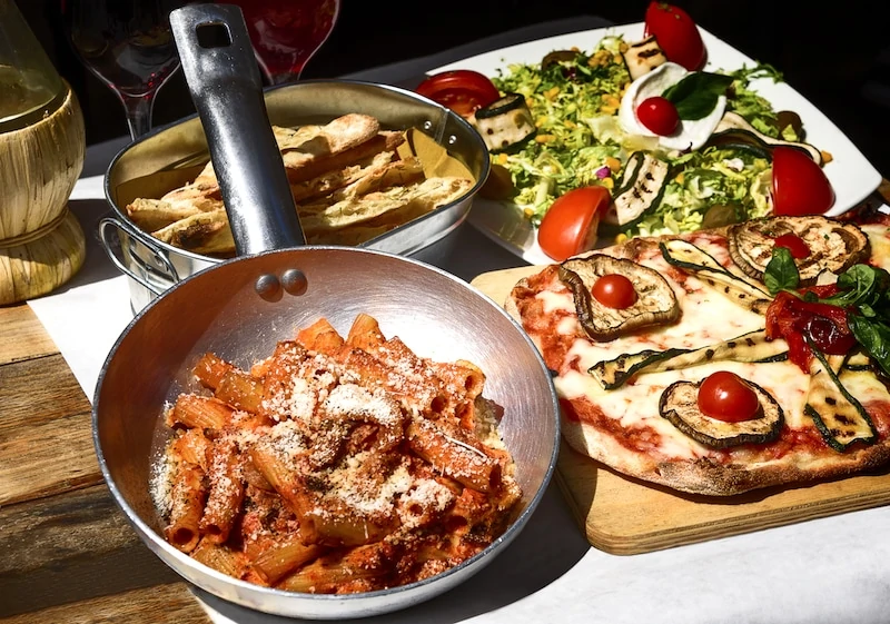 A skillet, salad and other famous Italian food to try on a food walking tour in Italy. Credit Deposit Photos