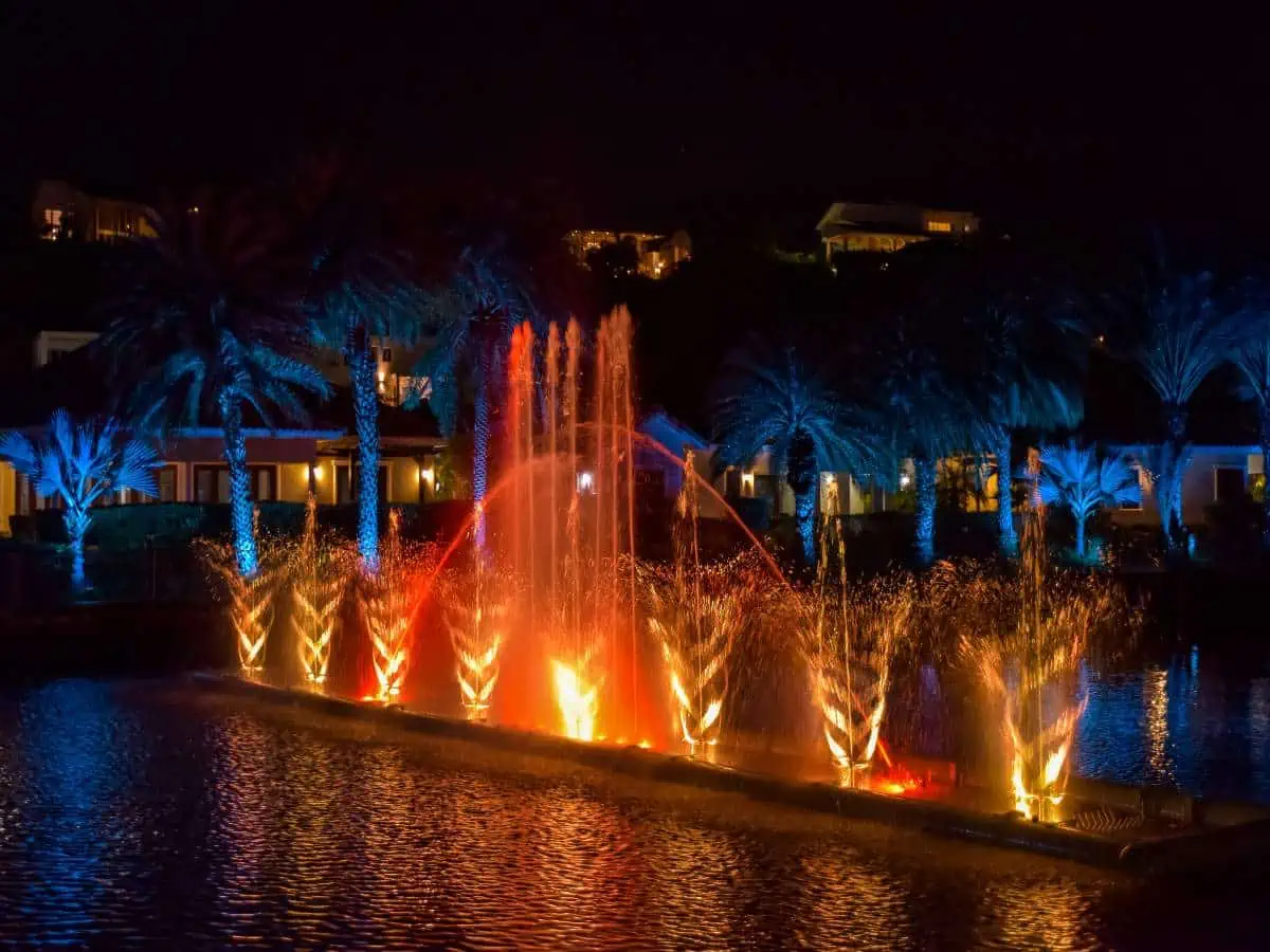 ACOYA CURAÇAO Resort, Villas and Spa pool fountain at night with lights.