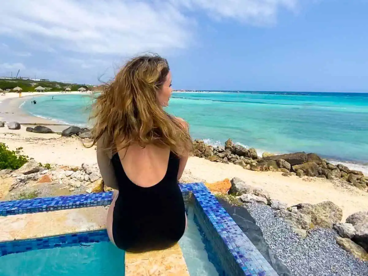 Young woman at the infinity pool at Rum Reef at Baby Beach.  