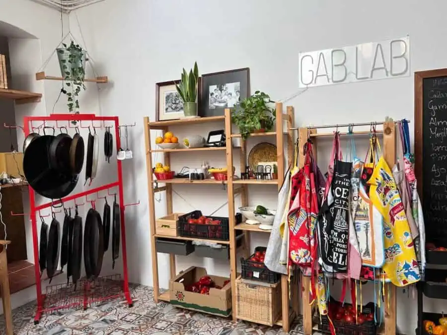 Aprons and paella pans at GAB LAB cooking studio in Barcelona. 