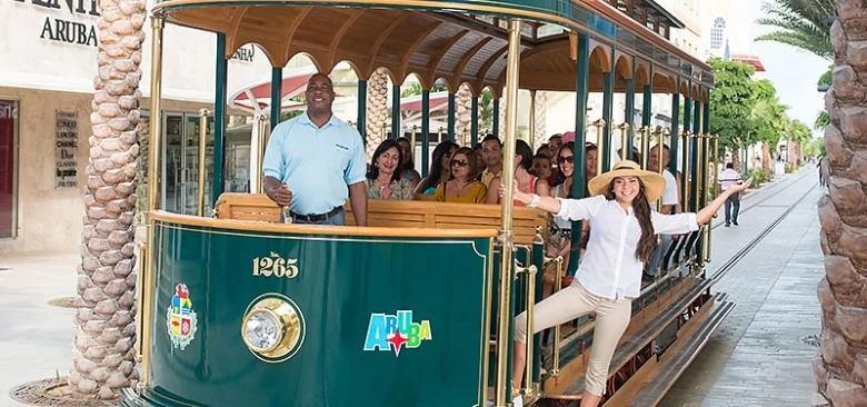 A woman riding the Aruba Trolley is one of the best free things to do in Aruba. 