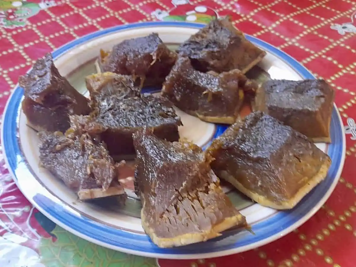 Pieces of Guatemalan ayote en dulce on a red tablecloth.