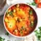 Bowl of bacalao finished and garnished with parsley.