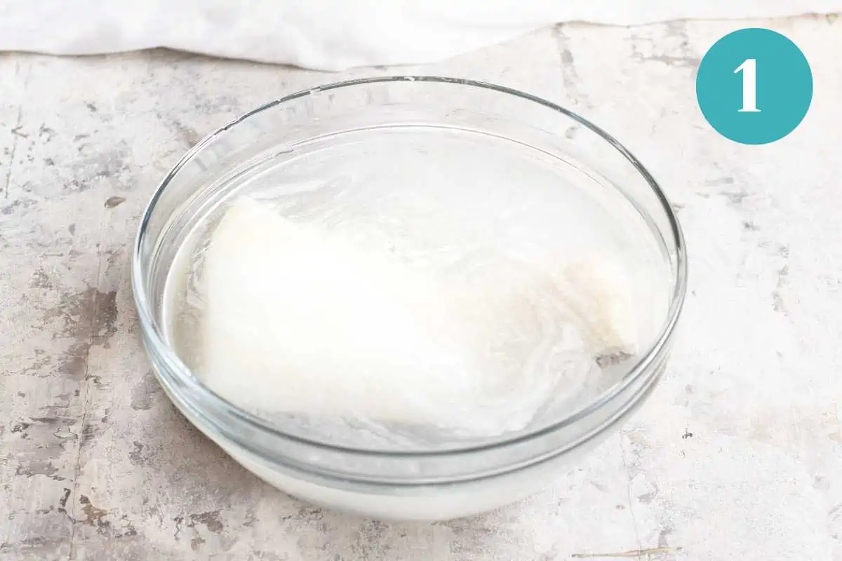 The salt cod soaking in water prior to cooking.