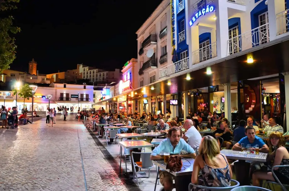 Bar with people at night in Albufeira Portugal.