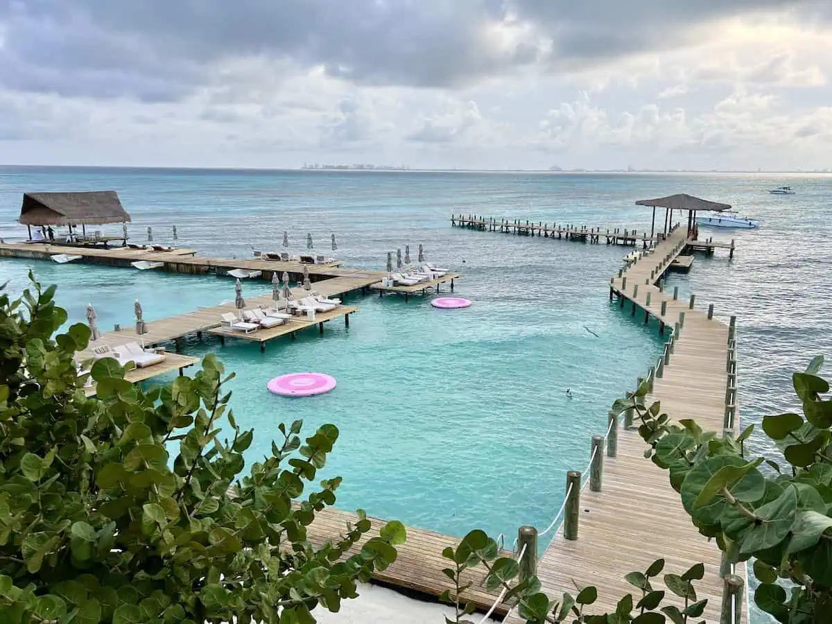 Beach zone, lounge chairs, water hammocks, pathways and yacht pier at Impression Isla Mujeres. 