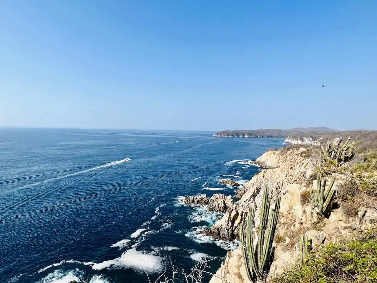 A tour boat off the rocky coast of the Bahias de Huatulco. 