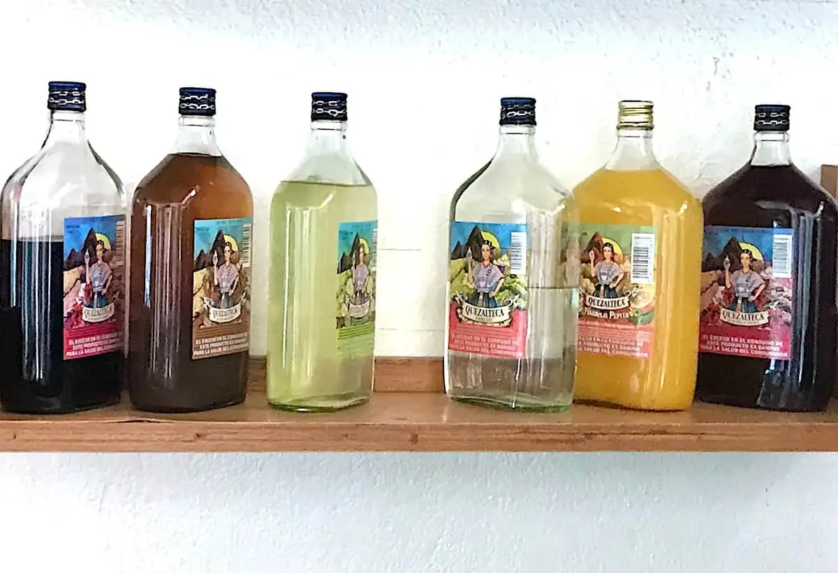 Bottles of Quetzalteca in a range of flavours on a shelf. (Credit: Michele Peterson) 