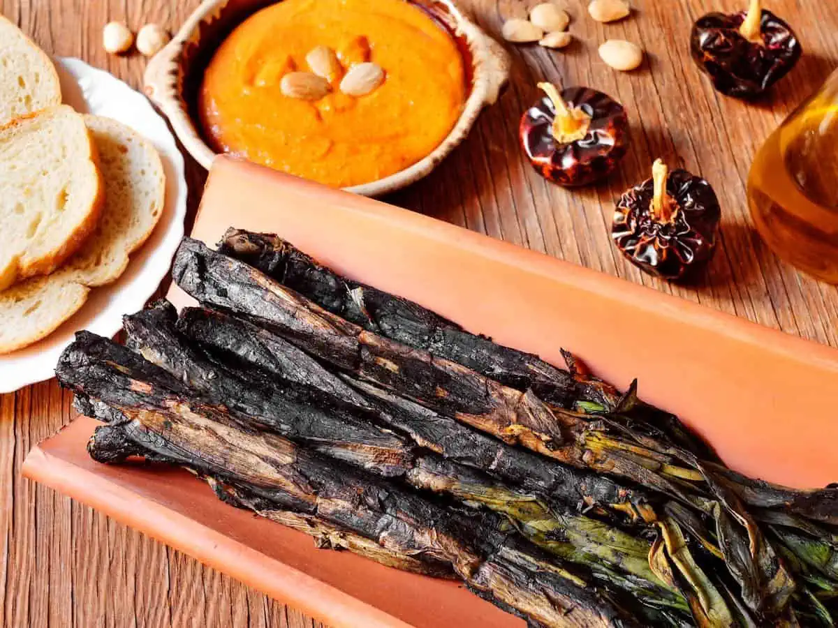 Grilled calcots ( onions) served with romesco sauce a typical Barcelona food in spring.