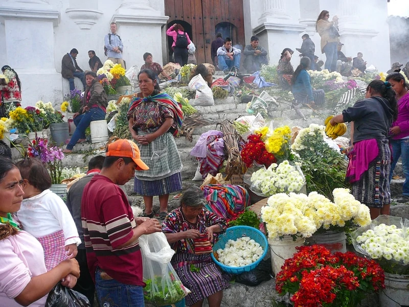 Flowers and vendors on the steps of the church in the K’iche’ Mayan town of Chichicastenango, Guatemala.