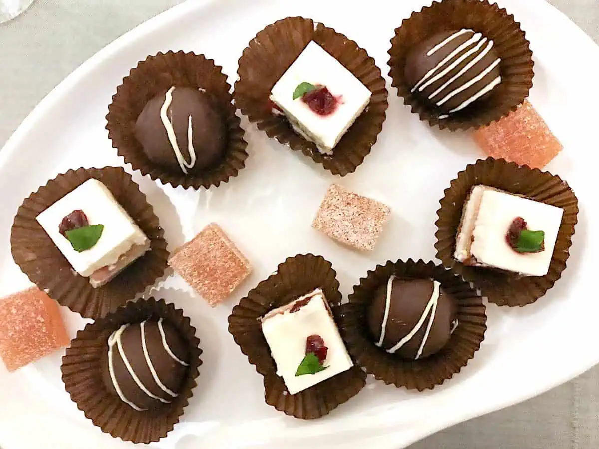a collection of chocolates on a white plate. 