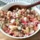 Traditional Guatemalan chojin radish and chicharrones salad in a white bowl.