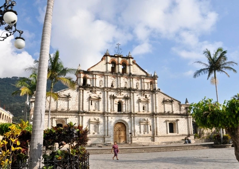 Woman walking past Church of St. Francis de Assisi in Panajachel Guatemala.