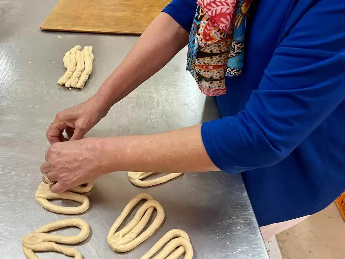 Woman leaning to make regional specialties at a cooking class in Greece. 