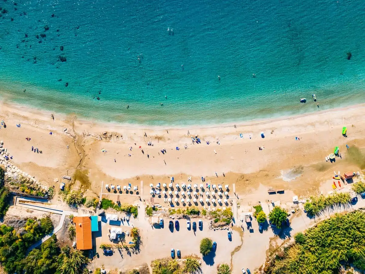 Drone view of blue waters of Coral Bay Beach in Paphos, Cyprus.