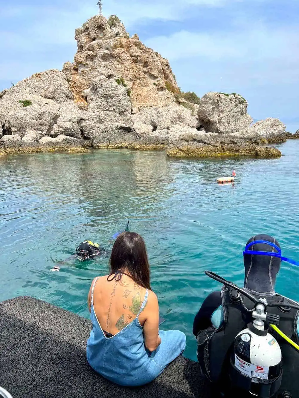 Person scuba diving in water. 