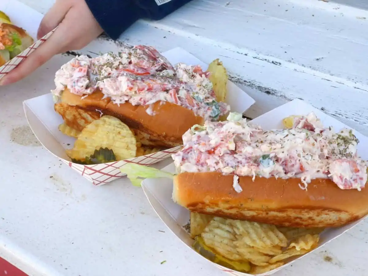 Two Lobster Rolls over chips in baskets.