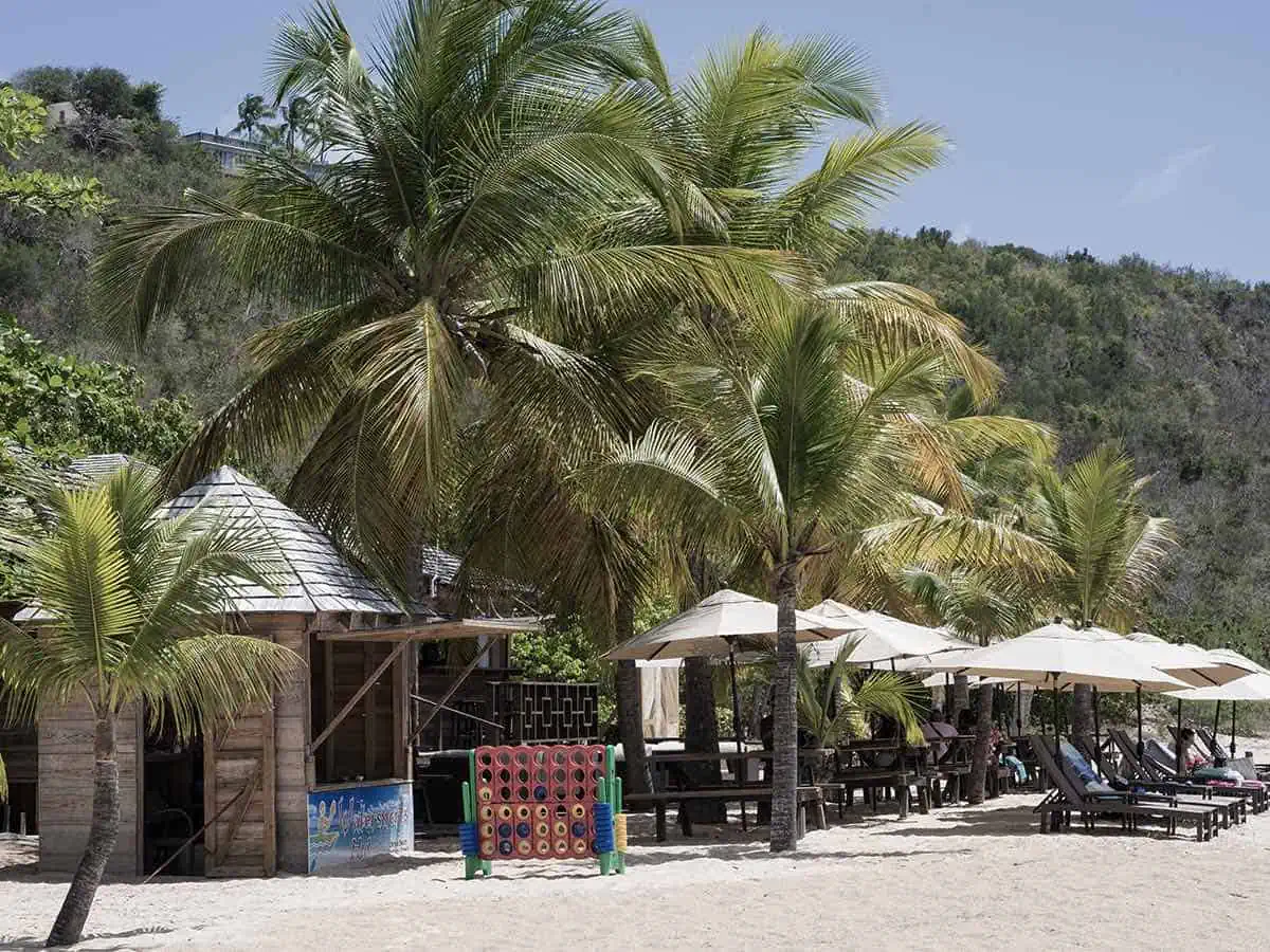 Palm trees and beach umbrellas at Beach Club, one of two places to eat at Da’Vida, a top restaurant in Anguilla. 