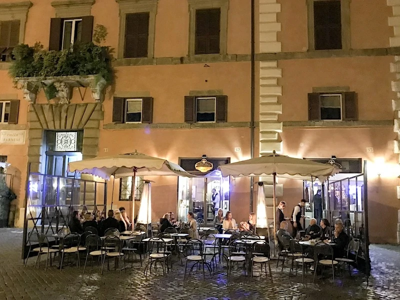 People dining in a restaurant outdoors in the Jewish Quarter of Rome.