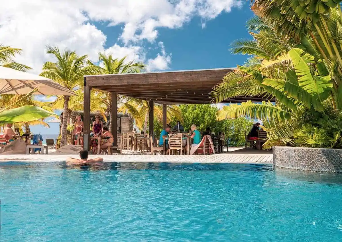 Man at swim-up bar in Bonaire, Dutch Caribbean.