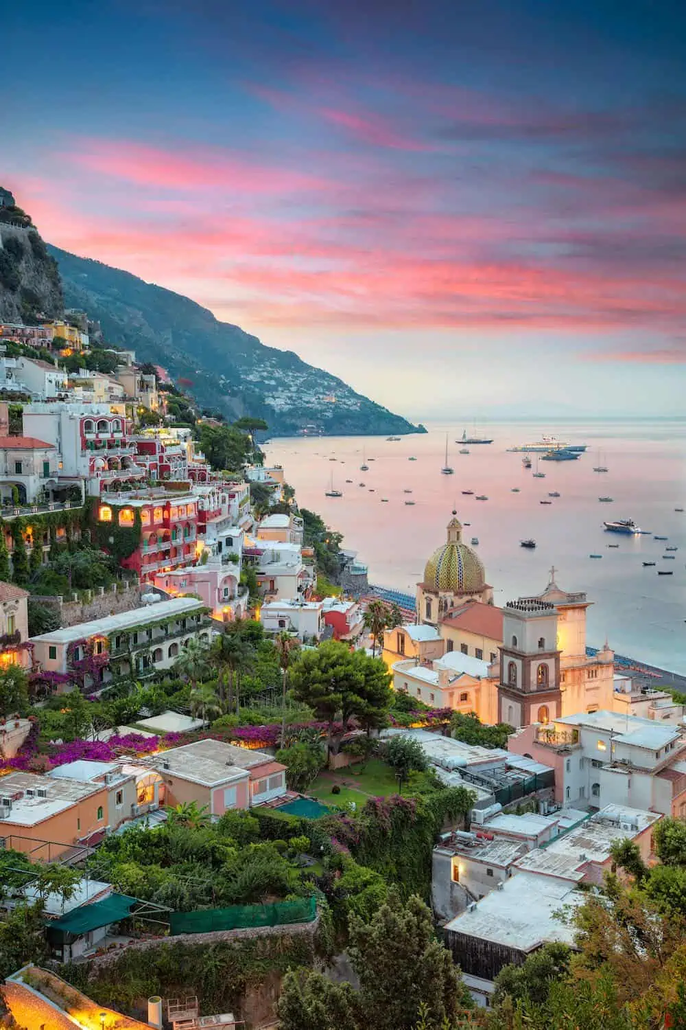 Evening view of Positano restaurants, town and sea. 
