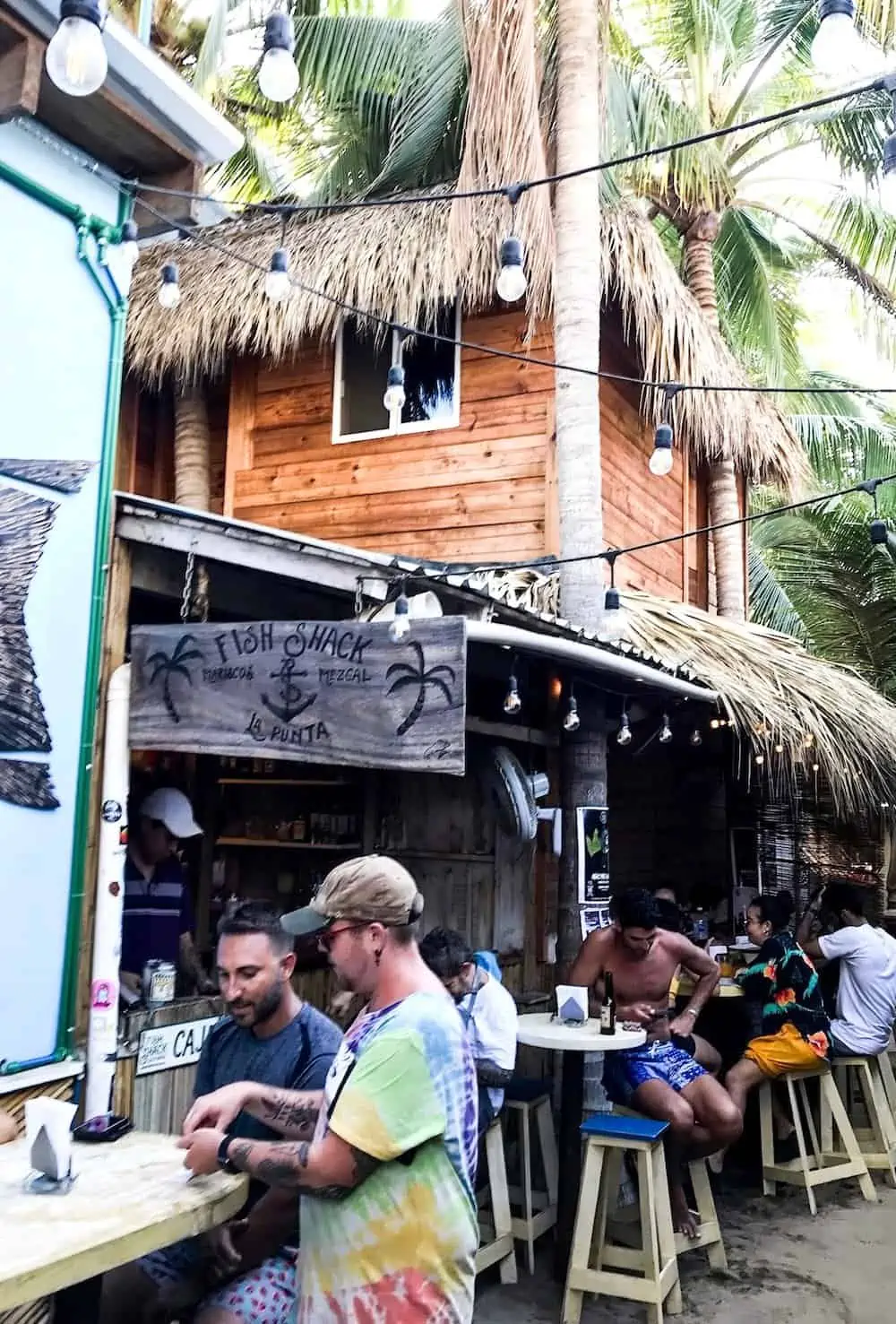 People sitting at Fish Shack restaurant in La Punta, Puerto Escondido. 