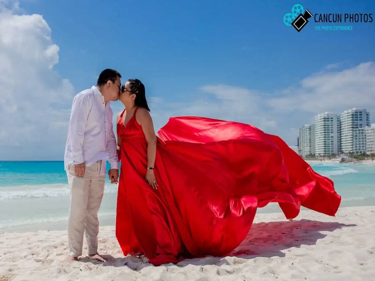 A couples flying dress photo shoot on the beach in Cancun. (Credit: Cancun Photos)