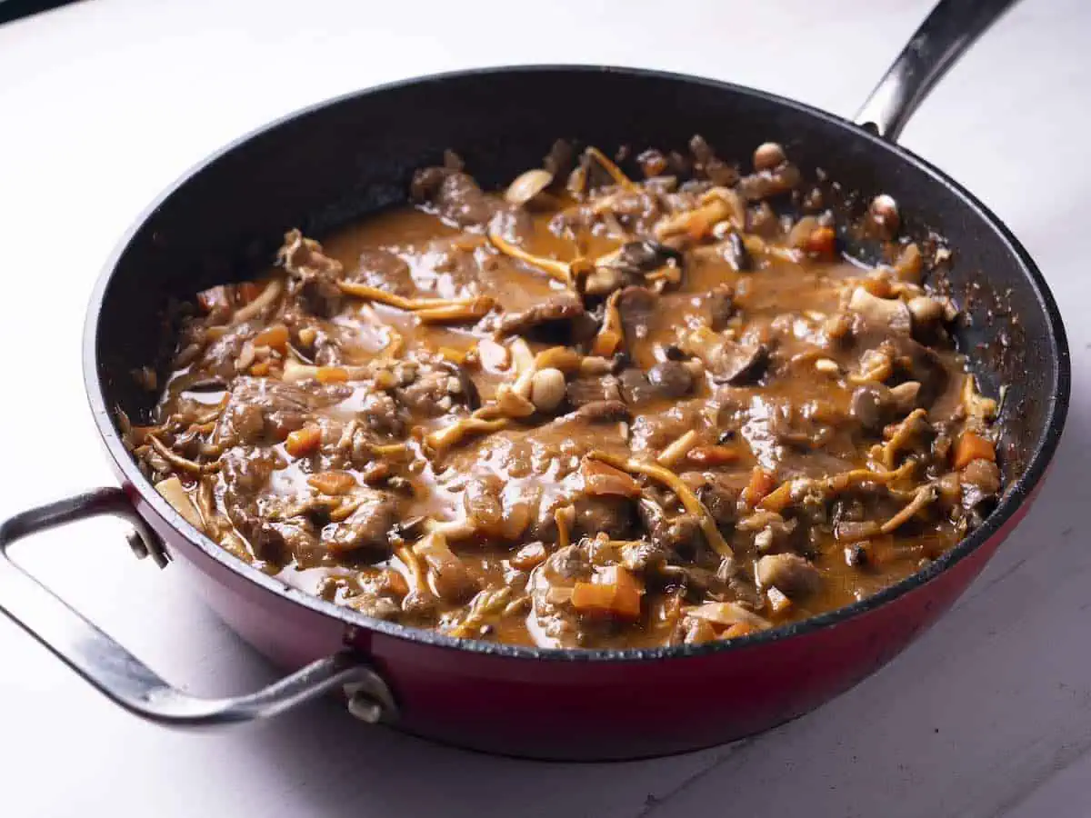 Fricando (slow-cooked beef in a red wine and mushroom sauce) in a braising pan. 