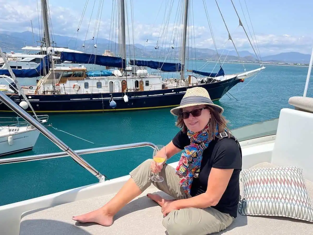 Lady on yacht with yacht in background. 