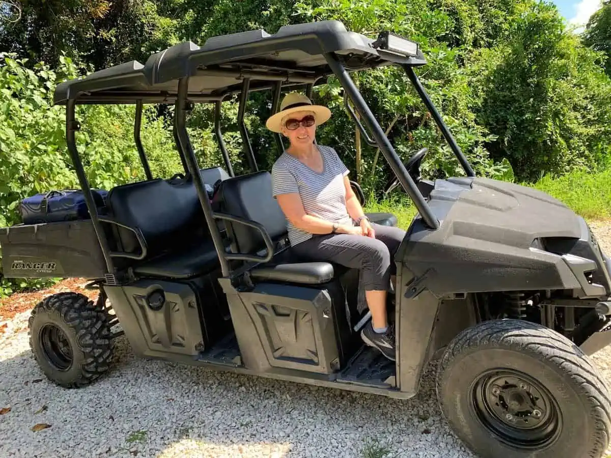 Writer Melody Wren in a golf cart in Belize.