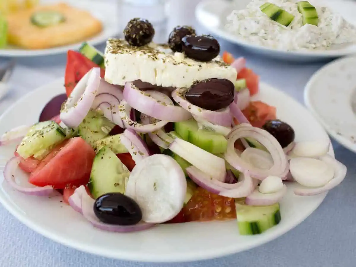 A Greek salad loaded with red onion, cucumber and Kalamata olives. 