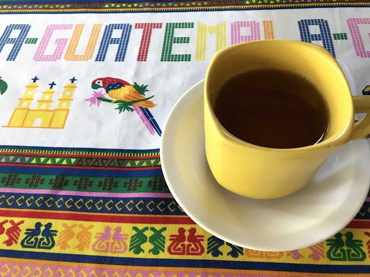 A cup of coffee on a Guatemalan tapestry.  