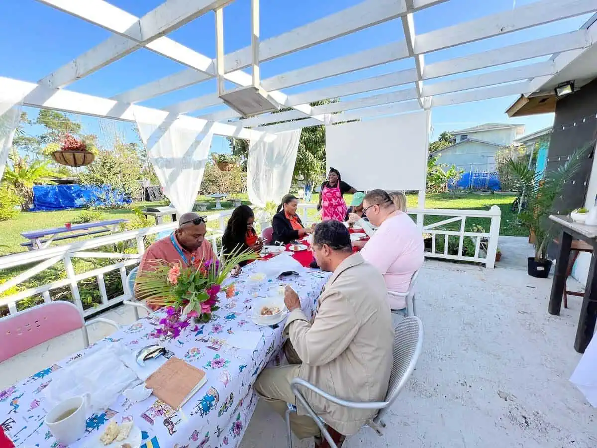 Guests enjoying breakfast at a table outside. 