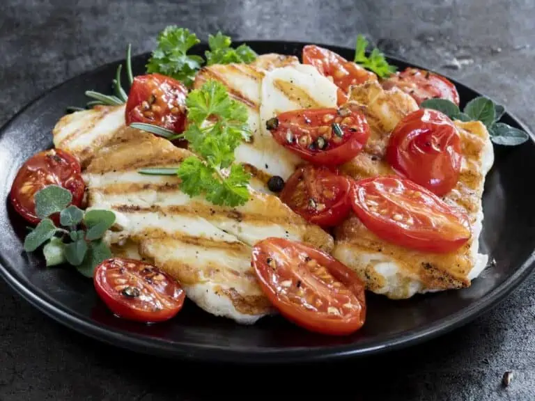 Halloumi cheese, grilled, with roasted cherry tomatoes and herbs.